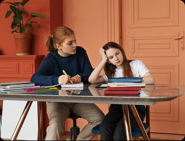 A mother helping her daughter study
