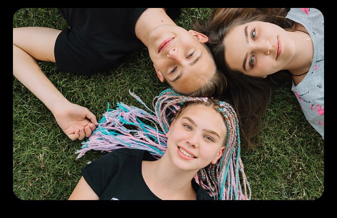 Students relaxing together on the grass