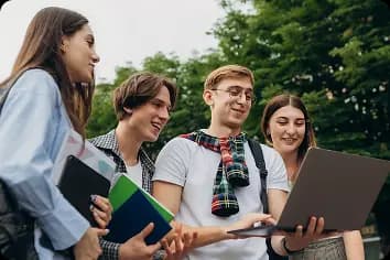 Група підлітків працює разом за ноутбуком